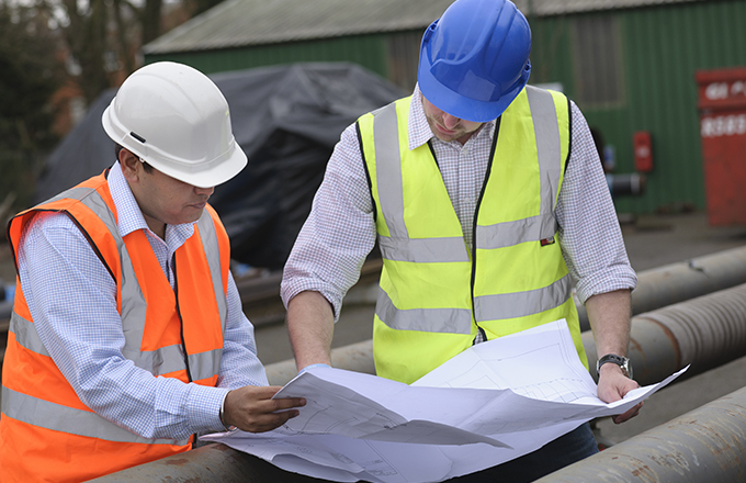 Students consulting bridge drawings